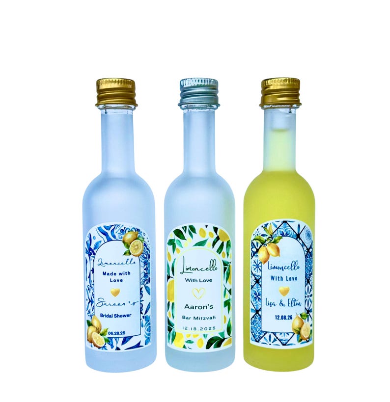 May include: Three small limoncello bottles with gold and silver caps. Each bottle has a unique label with text and lemon illustrations. The bottles are for a bridal shower, a Bar Mitzvah, and a wedding.