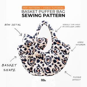 May include: A cream-coloured basket puffer bag sewing pattern with a black floral design and a bow detail. The bag has a basket shape and a puffed effect. The image text says "PDF Pattern + Video Tutorial" and "Sewing Pattern".