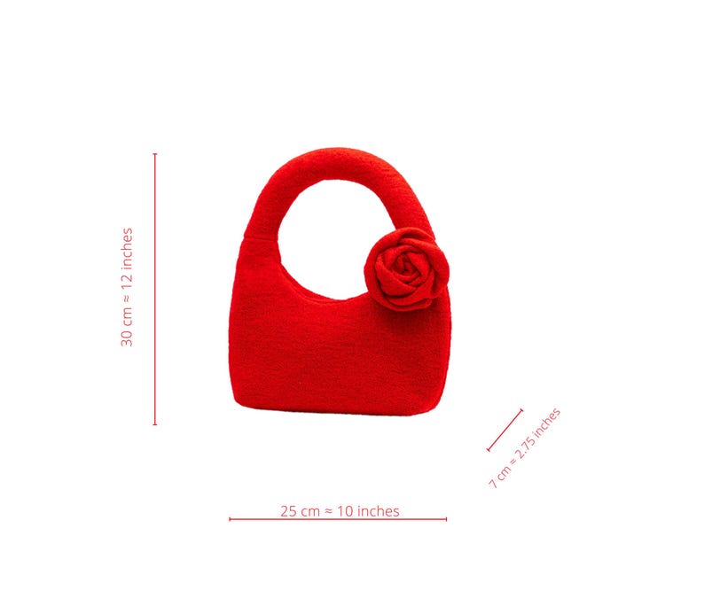 May include: A vibrant red handbag with a rounded handle and a decorative rose. The bag is approximately 10 inches wide, 12 inches tall, and 2.75 inches deep. The bag is made of a soft material and is suitable for carrying small items.