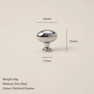 May include: A polished chrome cabinet knob made of zinc alloy. The knob is oval-shaped, measuring 33mm wide and 35mm tall. The base is 17mm wide. The knob weighs 60g. Suitable for furniture hardware.