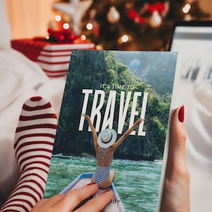 May include: A travel magazine with the words "IT'S TIME TO TRAVEL" on the cover is held in a person's hands. The magazine shows a woman in a swimsuit on a boat. Red and white striped socks are visible.