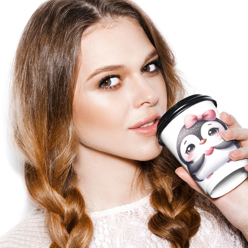 A woman with long brown hair is holding a coffee cup with a penguin design, smiling at the camera.
