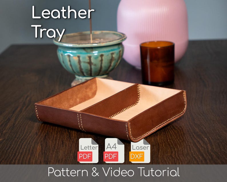 May include: A brown leather tray with three compartments, featuring visible stitching. The tray is labelled "Leather Tray" and includes icons for PDF and DXF files, along with the text "Pattern & Video Tutorial."