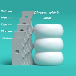 Könnte beinhalten: Ein weißer Keramik-Pflanztopf mit drei übereinander gestapelten runden Abschnitten. Der Topf ist neben einer Größenübersicht mit Maßen in Zentimetern abgebildet: 8 cm, 10 cm, 12 cm, 14 cm und 16 cm. Der Text "Wählen Sie die Größe!" steht über dem Topf.