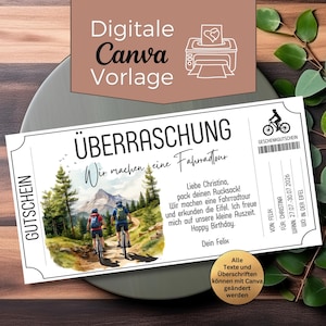 May include: A white gift certificate with the text "ÜBERRASCHUNG" and "Wir machen eine Fahrradtour". The certificate features a watercolor illustration of two cyclists on a mountain trail. The text "Happy Birthday" is also visible.