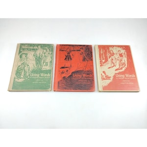May include: Three vintage books titled "Using Words" are displayed. The books have different colored covers: green, red, and red-orange. Each cover features illustrations and text. The books are arranged side by side on a white surface.