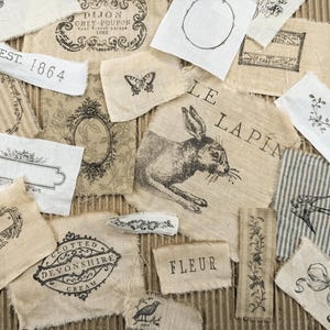 May include: A collection of fabric patches with vintage-style illustrations and text. Designs include a rabbit, butterfly, floral elements, and text such as "EST. 1864" and "FLEUR". The patches are in neutral tones of beige, cream, and white.
