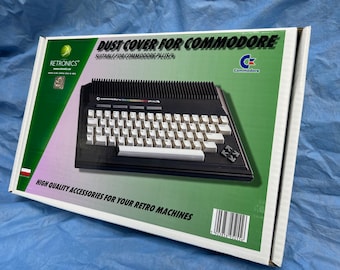 Può includere: Una scatola bianca con accenti verdi e rosa. La scatola presenta un'immagine di un computer Commodore Plus/4 nero con una tastiera bianca. Il testo sulla scatola recita "DUST COVER FOR COMMODORE" e "SUITABLE FOR COMMODORE PLUS/4". Il testo "RETRONICS" si trova nell'angolo in alto a sinistra della scatola. Il testo "HIGH QUALITY ACCESSORIES FOR YOUR RETRO MACHINES" si trova nella parte inferiore della scatola.