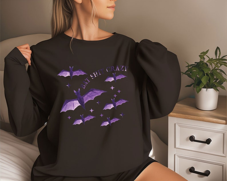 May include: Black sweatshirt with a purple bat graphic and the text "Bat Shit Crazy".