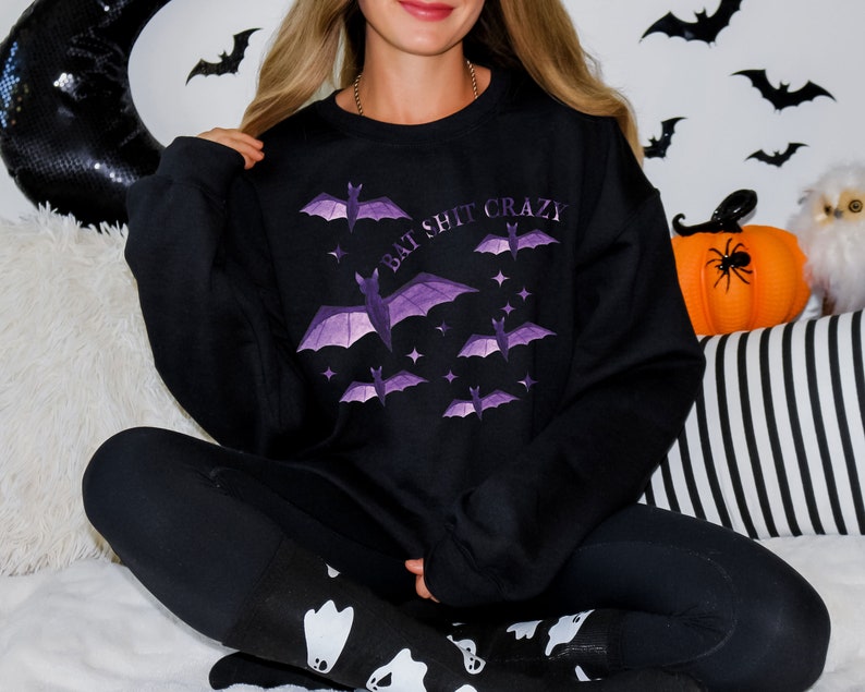 May include: Black sweatshirt with a purple bat graphic and the text "Bat Shit Crazy".