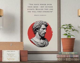 May include: A framed print with a quote by Marcus Aurelius and a bust of a man against a red circle. The print is displayed on a dark wood table with a plant, books, and decorative boxes. Two gold and glass pendant lights hang above.