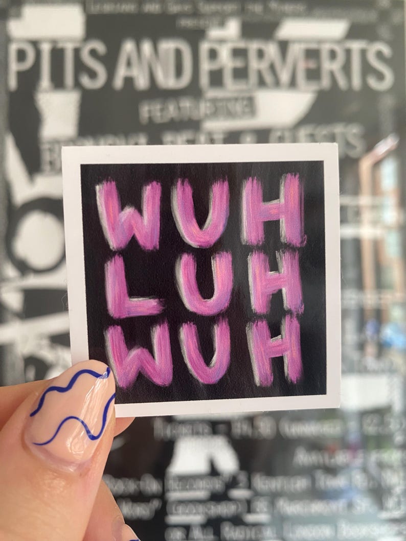 May include: Square sticker with the text "WUH LUH WUH" in pink brushstrokes on a black background. The sticker is held up by a hand with a light pink nail with blue wavy lines.