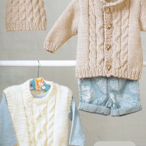May include: A set of three knitted garments in beige and white, including a cardigan, a vest, and a hat. The garments are made with a chunky yarn and feature a cable knit pattern. The text "Chunky / Bulky 18 - 24 ins" is visible in the image.