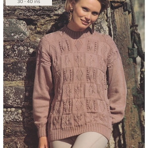 May include: A pink knitted sweater with a cable knit pattern. The sweater is 4 ply and fits sizes 30-40 inches.