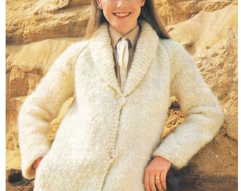 May include: A white knitted cardigan with a shawl collar, button fastening, and long sleeves. The cardigan is being worn by a woman with long brown hair and a white collared shirt. The text "Wendy Lima Chunky/Bulky 32-40 ins" is visible at the top of the image.