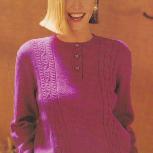 May include: A magenta knitted sweater with a cable knit pattern and four buttons down the front. The sweater is 76-102 cm in length.