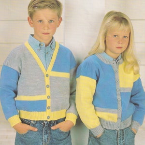 May include: Two children wearing colorful knitted cardigans. The boy's cardigan is gray, blue, and yellow with a button closure. The girl's cardigan is blue, yellow, and gray with a button closure. Both cardigans are made with DK yarn and are for sizes 24-34 inches.