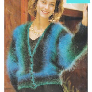 May include: A blue and green mohair cardigan with a fuzzy texture. The cardigan has a V-neck and buttons down the front.  Mohair Batwing Cardigan 30/32 to 42/44 inch