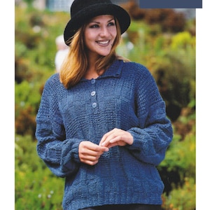 May include: A blue knitted sweater with a collared neckline and button closure. The sweater has a textured pattern and is worn by a person with a black hat. Aran / Worsted Yarn 32/34 to 36/38 ins
