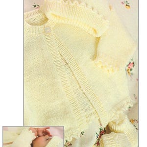 May include: A yellow knitted baby cardigan, hat and socks set for premature to 12 month old babies. The set is made with 4 ply yarn.