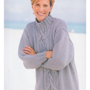 May include: A grey cable knit jumper with a high neck. The jumper is made with chunky yarn and has a relaxed fit. Merino Chunky 32 - 44 ins