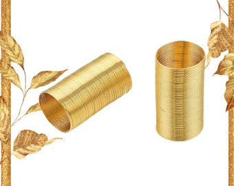 May include: Two gold metal bangles, one lying flat and the other standing upright. The bangles are made of thin, coiled wire.