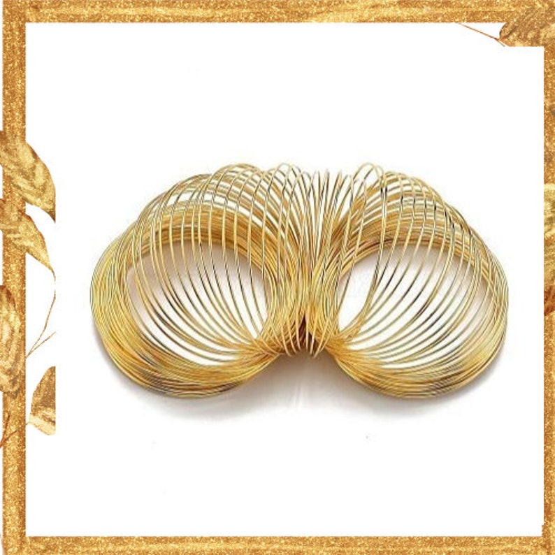 May include: A gold-colored metal spring toy featuring a continuous coiled wire design. The object is composed of numerous circular loops that form a flexible, expandable structure with a metallic finish and a reflective, shiny surface texture.