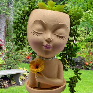 Girl Face "Daysi" Planter pot This girl face pot have also a tray, and 4 non slip mat on the bottom. also she have a rhinestones necklace.