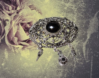 Vintage brooch 2.5&quot; wide and 2&quot; tall plus 1&quot; of dangling little charms, silver with one black stone and many miniature black stones