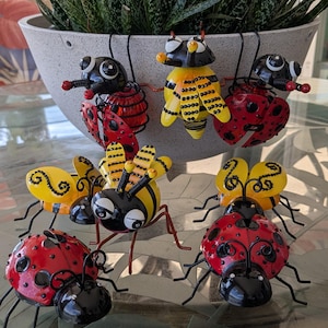 Cute metal bumble bees and ladybugs embellished with rhinestones to add more sparkle to your plant pots,