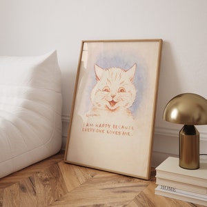 May include: A framed illustration of a white cat with a big smile. The cat is drawn in a watercolour style on a light blue background. The text below the cat reads "I am happy because everyone loves me."