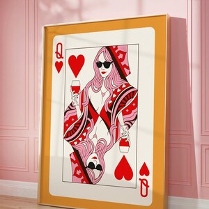 May include: A Queen of Hearts playing card illustration with a woman wearing sunglasses and holding a glass of wine. The card is framed in a gold frame and has a yellow background.