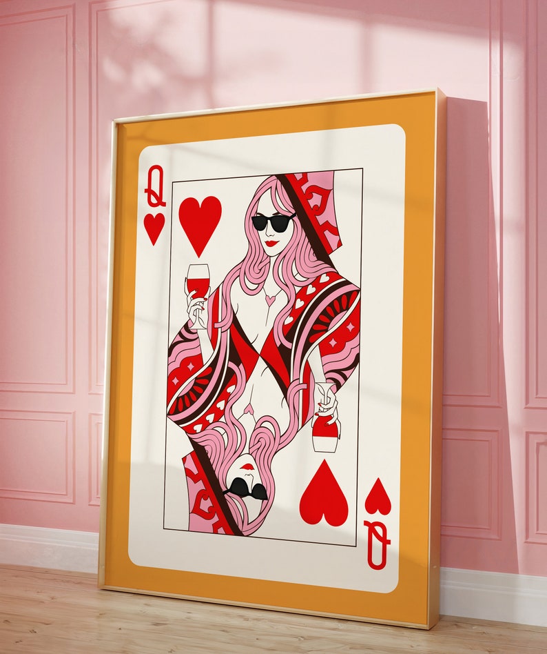 May include: A Queen of Hearts playing card illustration with a woman wearing sunglasses and holding a glass of wine. The card is framed in a gold frame and has a yellow background.