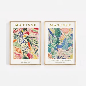 Puede incluir: Dos impresiones de arte enmarcadas de pinturas de Henri Matisse. La impresi&oacute;n de la izquierda se titula "Japonesa" y representa un paisaje abstracto colorido. La impresi&oacute;n de la derecha se titula "Paisaje en Collioure" y presenta un estilo abstracto similar con colores vibrantes.