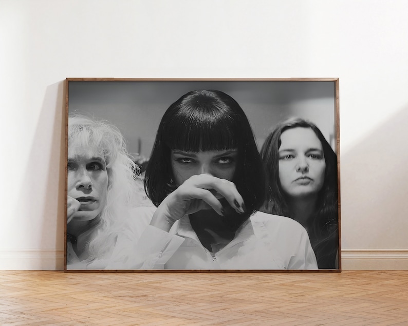 May include: Black and white photograph of three women. The woman in the center is wearing a white shirt and has her hand covering her mouth. The woman on the left is wearing a white shirt and has her hair pulled back. The woman on the right is wearing a white shirt and has her hair down.