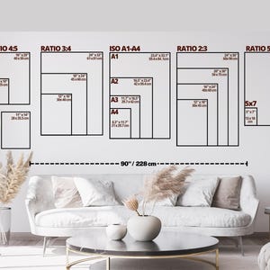 May include: A wall with various framed art print sizes, including 8x10 inches, 16x20 inches, and 24x36 inches. The image also shows a sofa, coffee table, and decorative elements. The total width of the wall art is 90 inches (228 cm).