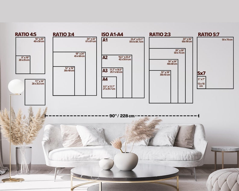 May include: A wall with various framed art print sizes, including 8x10 inches, 16x20 inches, and 24x36 inches. The image also shows a sofa, coffee table, and decorative elements. The total width of the wall art is 90 inches (228 cm).