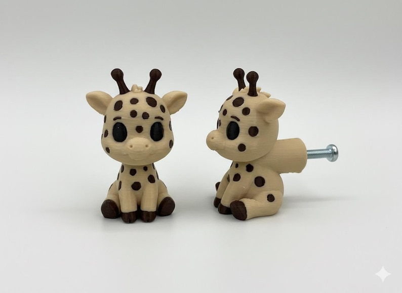 Peut inclure: Deux boutons de meuble en forme de girafe. Les boutons sont de couleur beige clair avec des taches et des accents brun fonc&eacute;. Chaque girafe a une vis m&eacute;tallique pour l'installation. Les girafes sont assises avec de grands yeux noirs.