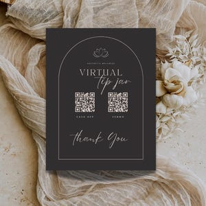 May include: Black and white sign with a lotus flower logo and the text "Aesthetic Wellness Virtual Tip Jar". Two QR codes are displayed with the text "Cash App" and "Venmo" below them. The sign also includes the text "Thank You".