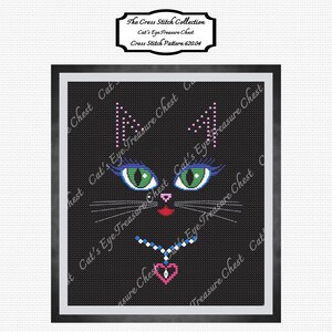 May include: Cross stitch pattern of a black cat's face with green eyes, blue eyelashes, a pink nose, and a red mouth. The cat is wearing a necklace with a pink heart pendant. The pattern is titled "Cat's Eye Treasure Chest" and the cross stitch pattern number is 620.04.