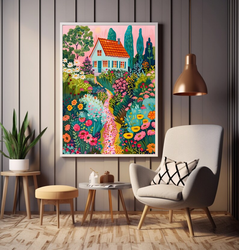 May include: A framed art print showing a garden path leading to a house with a red roof and blue walls. The artwork features vibrant flowers, trees, and a pink sky, creating a whimsical scene. The print is displayed in a modern living room setting.