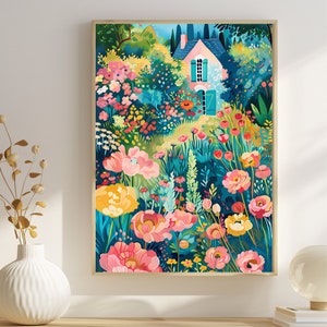 May include: A framed art print of a colorful garden scene. The artwork features a small house with a pink roof and turquoise shutters, surrounded by vibrant flowers in shades of pink, yellow, and red. The background is a mix of green foliage and blue sky.