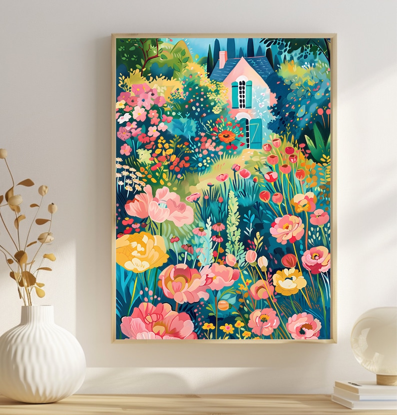 May include: A framed art print of a colorful garden scene. The artwork features a small house with a pink roof and turquoise shutters, surrounded by vibrant flowers in shades of pink, yellow, and red. The background is a mix of green foliage and blue sky.