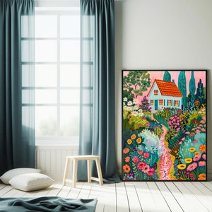May include: A framed art print showcasing a vibrant garden scene with a small house. The house features a red tiled roof and blue walls, surrounded by colorful flowers and lush greenery. The artwork is set against a pink sky, creating a cheerful atmosphere.