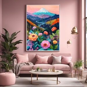 Puede incluir: Una impresi&oacute;n art&iacute;stica enmarcada que representa un vibrante paisaje monta&ntilde;oso con una cima nevada, un r&iacute;o sinuoso y flores coloridas. La obra de arte presenta una paleta de rosas, naranjas, azules y verdes, creando una escena animada. La impresi&oacute;n se exhibe sobre un sof&aacute; rosa.