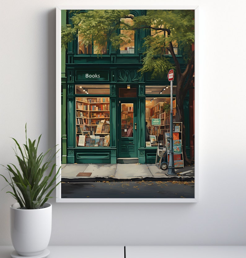 May include: A framed print depicting a green bookstore exterior. The shop front features the word "Books" above the entrance. The windows reveal shelves of books. A tree provides shade, and a potted plant is in the foreground. The image evokes a cozy atmosphere.