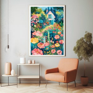 May include: A framed art print depicts a colorful garden scene with a pink house. The artwork features vibrant pink, yellow, and red flowers, lush greenery, and a blue sky. The print is displayed in a living room setting with an orange armchair and side table.