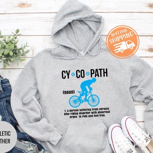 May include: Athletic heather gray hoodie with the text "CY CO PATH" and a blue graphic of a cyclist. The hoodie includes the definition of "CY CO PATH" and the words "ATHLETIC HEATHER".