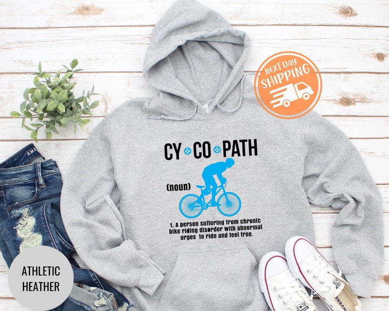 May include: Athletic heather gray hoodie with the text "CY CO PATH" and a blue graphic of a cyclist. The hoodie includes the definition of "CY CO PATH" and the words "ATHLETIC HEATHER".