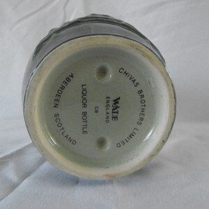 May include: A green ceramic liquor bottle with the text "Chivas Brothers Limited" and "Wade England" on the bottom. The bottle also says "Liquor Bottle CB Aberdeen Scotland".